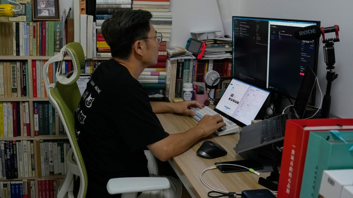 Former software engineer Fei Zhaojun works from his home in Beijing after losing his job amid China’s AI boom.