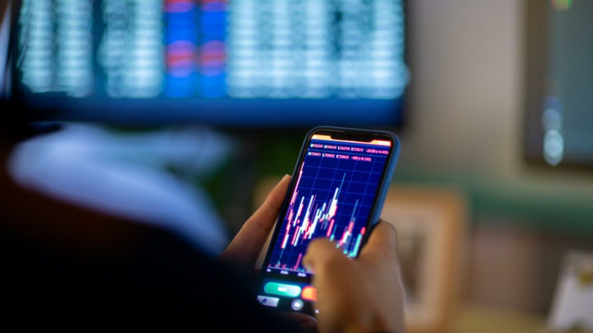 A trader trading crypto on their phone.