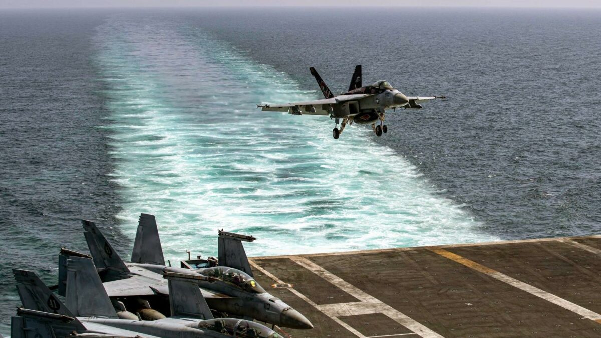 An F/A-18E Super Hornet, attached to Strike Fighter Squadron (VFA) 14, makes an arrested landing on the flight deck of Nimitz-class aircraft carrier USS Abraham Lincoln