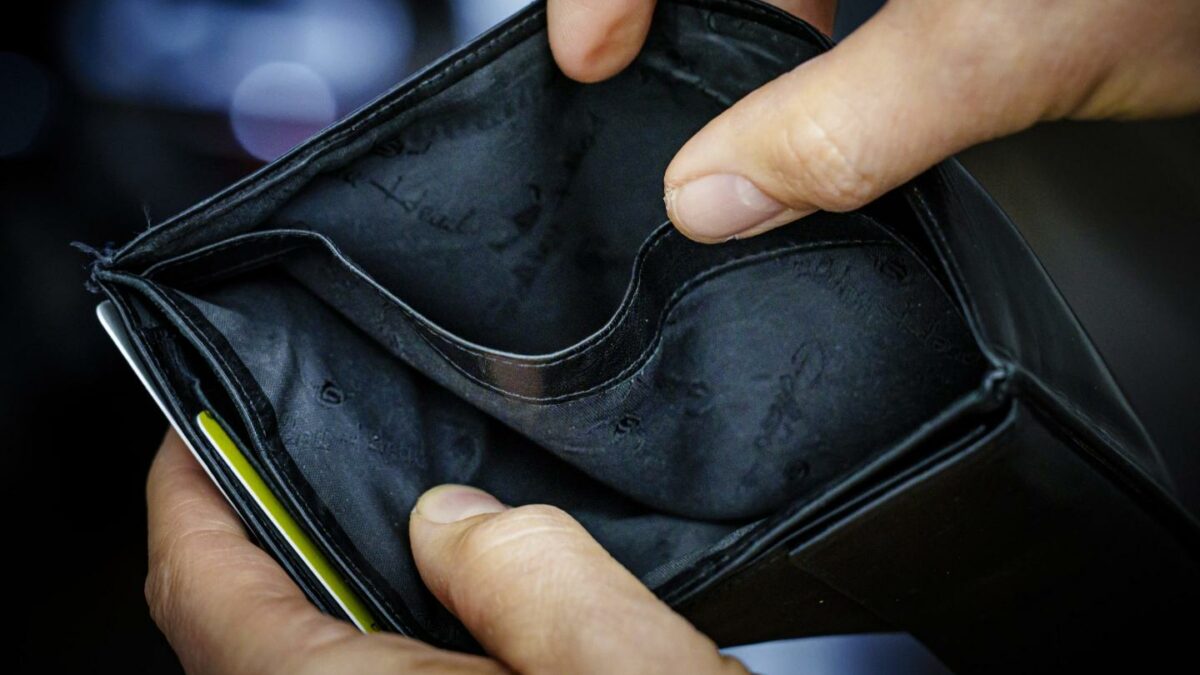 Photo of empty wallet with hands holding it open