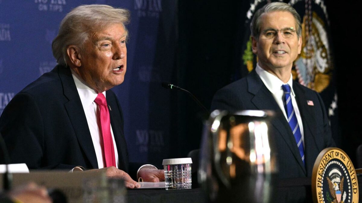 Donald Trump and Scott Bessent sit next to each other.
