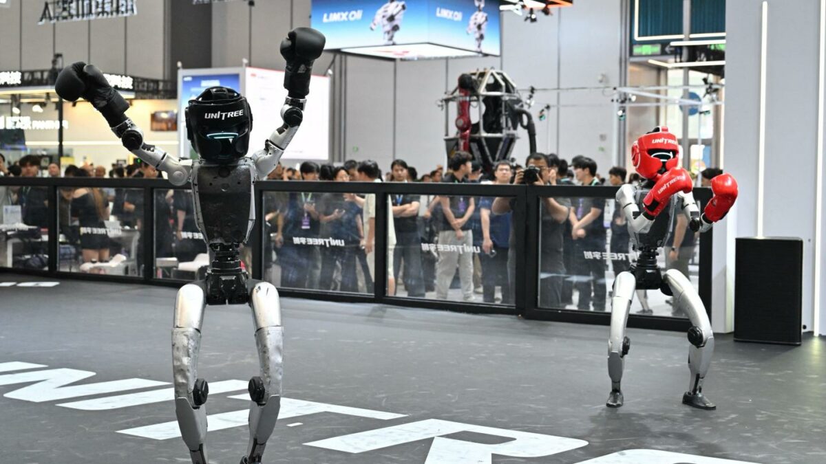 Two robots produced by Unitree take part in a fighting demonstration during the 2026 World Robot Conference in Beijing on August 19, 2026.