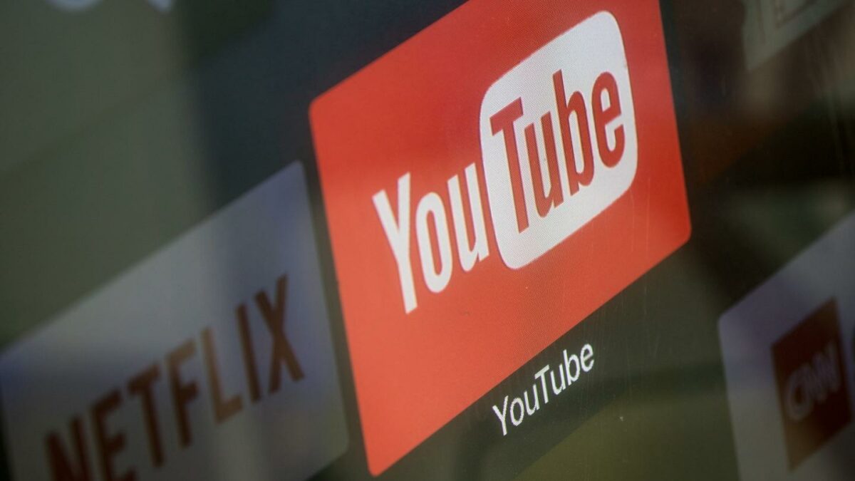Photo of YouTube logo and Netflix creeping up behind it