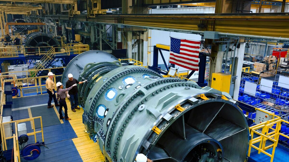 Chevron employees examine a new GE Vernova gas turbine.
