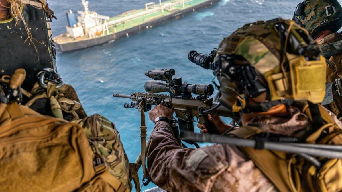 A U.S. Marine with Battalion Landing Team 3/5, 11th Marine Expeditionary Unit, sights in on a M110 semi-automatic sniper system during a maritime interception operation in the U.S. Central Command area of responsibility, July 16, 2026.