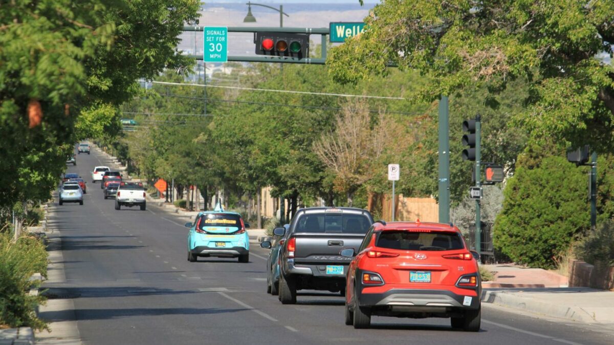 Vehicles stop along Lead Avenue where stoplights are set for a specific speed limit as part of the "rest on red" signal program in Albuquerque, N.M., Wednesday, Aug. 12, 2026.