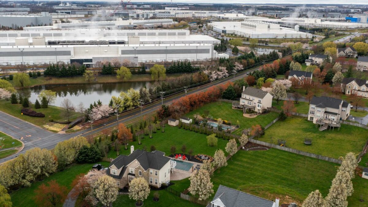 Data centers near a housing development in Ashburn, Virginia, on Wednesday, March 27, 2024.