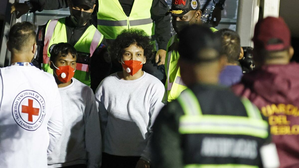Venezuelan influencer Leonel Moreno (C) - aka "Leito oficial"- deported from the United States is escorted on arrival at Simon Bolivar International Airport in Maiquetia, Venezuela on March 28, 2025.
