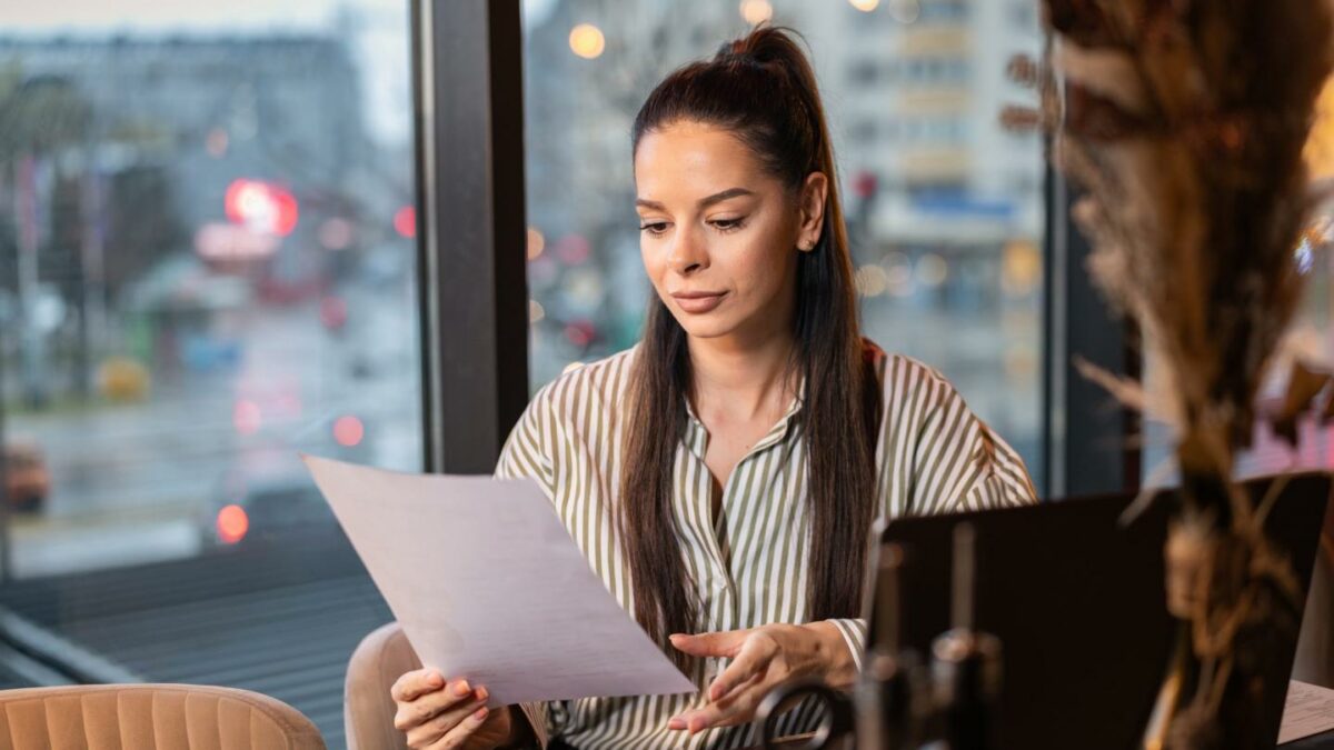 A person at a desk looking over a form.