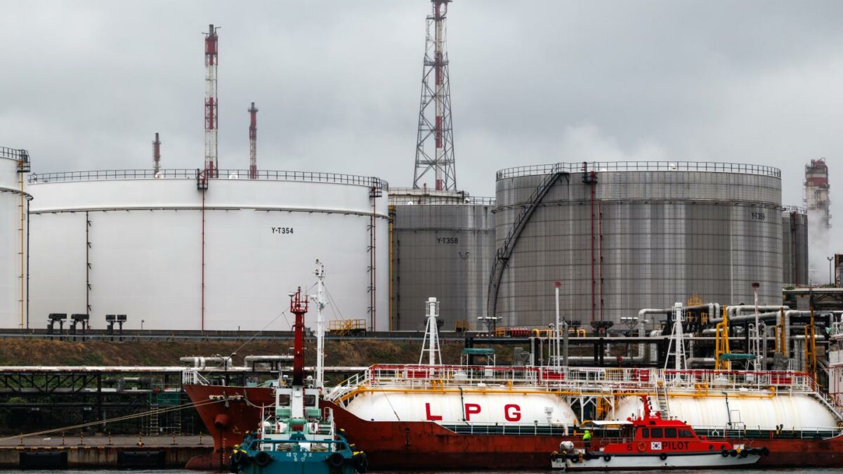 A liquefied petroleum gas (LPG) tanker in front of oil tanks at the SK Innovation Co. Ulsan Complex oil refinery facilities at dawn in Ulsan, South Korea, on Wednesday, June 24, 2026.