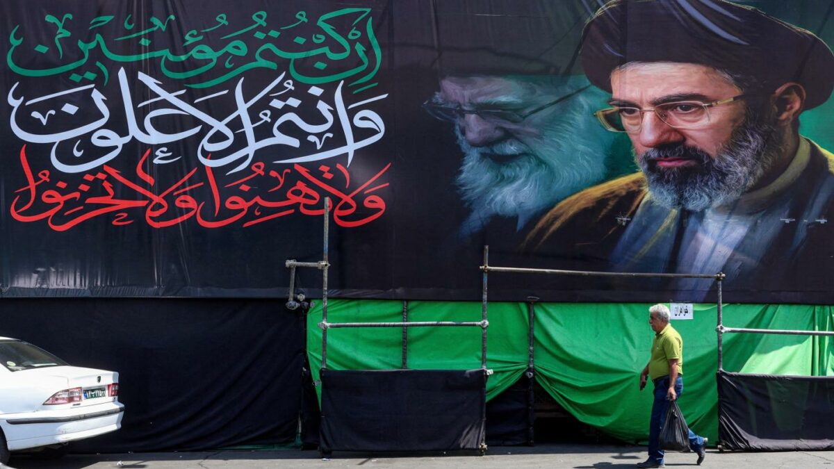 A banner depicting Iran's current supreme leader Mojtaba Khamenei and his late father Ali Khamenei along a road in Tehran on June 30, 2026.