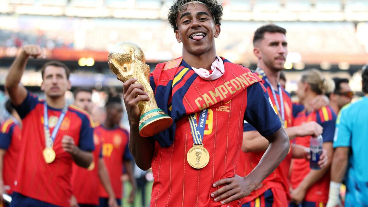 Lamine Yamal of the Spanish National Team poses with the FIFA World Cup trophy following Spain's victory in the World Cup Final.