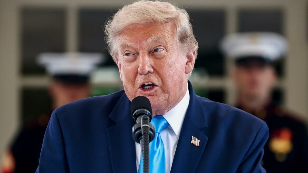 Donald Trump speaks into a microphone.