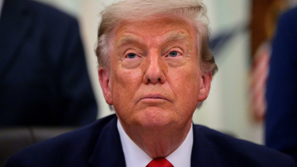 President Donald Trump looks on during an announcement.