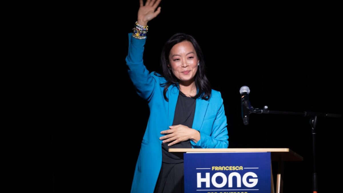 Francesca Hong smiles and waves at the crowd during an election-night party.