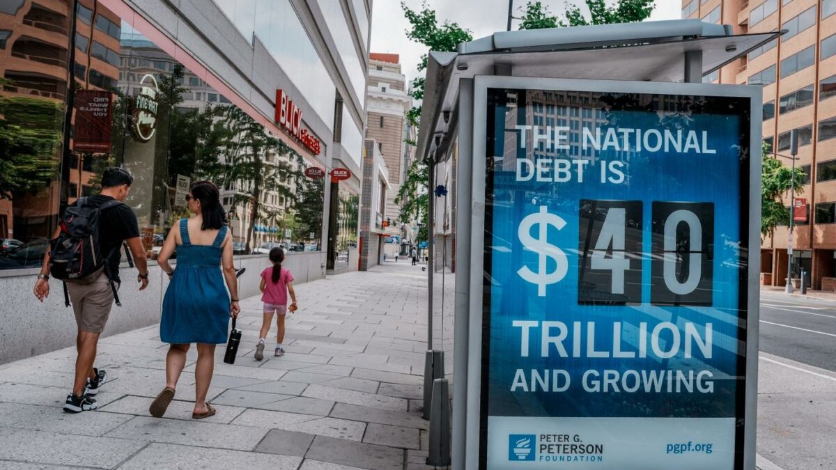 A view of a bus shelter at 13th and I St's NW where an electronic billboard and a poster display the current U.S. National debt per person and as a nation at 40 Trillion Dollars on August 30, 2026 in Washington, DC.