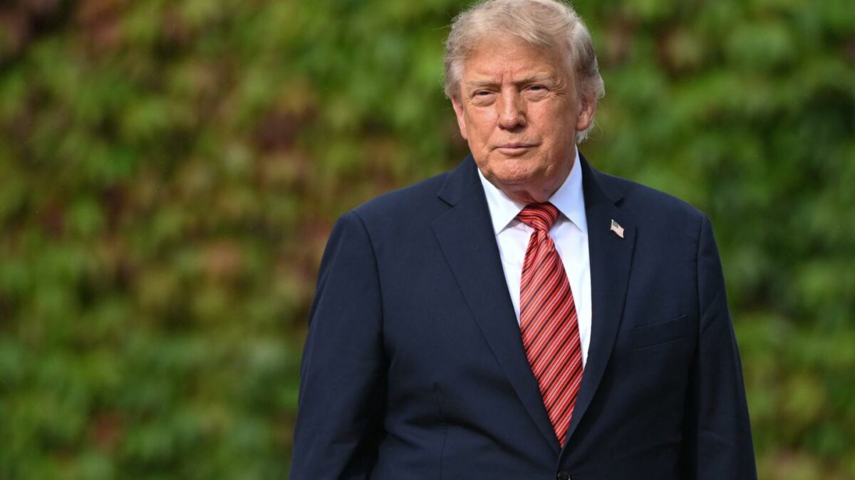 U.S. President Donald Trump pauses as he walks alone along an ivy-covered wall during his final departure from Aras an Uachtarain on September 12, 2026, in Dublin, Ireland.