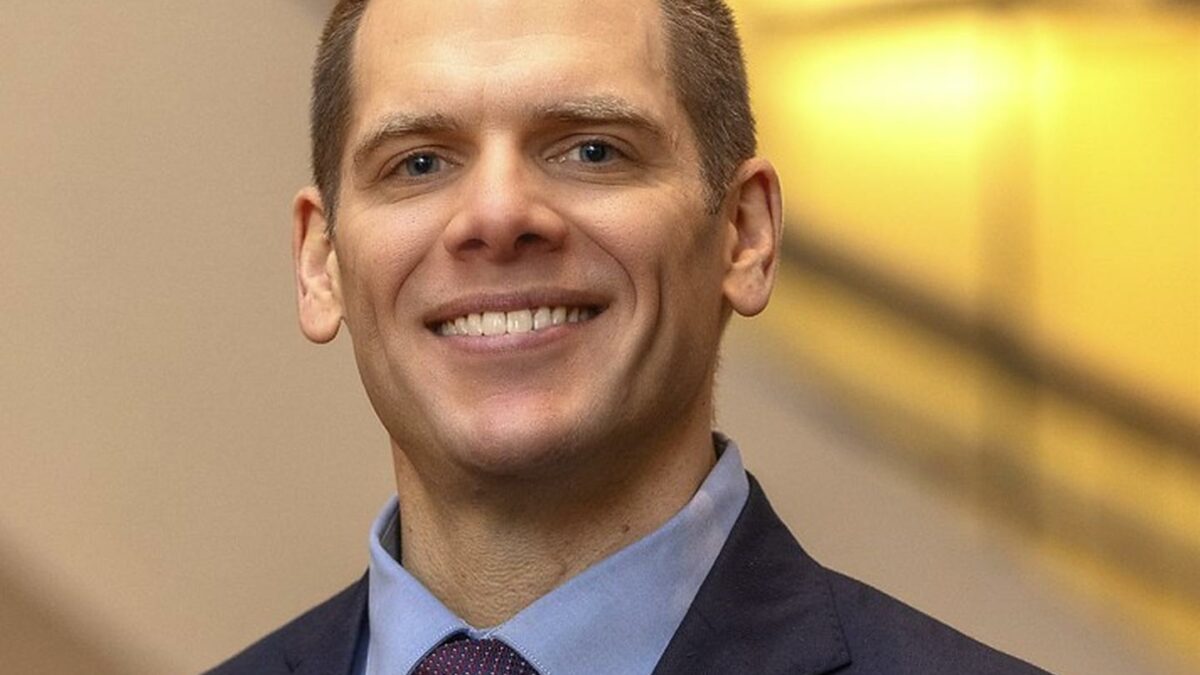 Man smiling in a suit and tie
