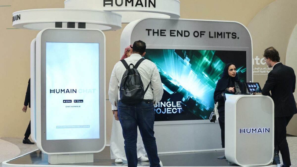 Guests stand at the booth of Saudi artificial intelligence company Humain during the Future Investment Initiative (FII) conference in Riyadh on October 29, 2025.